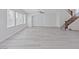 Spacious living room featuring wood floors, a large window, and staircase at 10469 Mulvaney Cir, Las Vegas, NV 89141