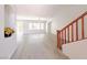 Bright living room featuring wood floors, large windows, and staircase at 10469 Mulvaney Cir, Las Vegas, NV 89141