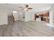 Inviting living space with wood floors that seamlessly connects living room, kitchen, and staircase at 10469 Mulvaney Cir, Las Vegas, NV 89141