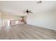 Spacious, naturally lit loft area featuring ceiling fan and wood-look flooring at 10469 Mulvaney Cir, Las Vegas, NV 89141