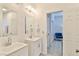 Bathroom featuring double sinks, mirrored vanities, and plenty of light at 10667 Olympic Pine Dr, Las Vegas, NV 89135