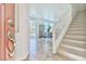 Bright entryway showcasing tile floors, staircase, and open access to living spaces at 10667 Olympic Pine Dr, Las Vegas, NV 89135