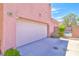 This home has a two car garage and long driveway with a pool view through the side gate at 10667 Olympic Pine Dr, Las Vegas, NV 89135