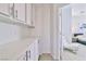 Upstairs hallway with built in storage and doorway to bedroom at 10667 Olympic Pine Dr, Las Vegas, NV 89135
