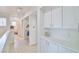 Upstairs hallway with built in storage and light plank flooring at 10667 Olympic Pine Dr, Las Vegas, NV 89135