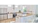 Well-lit kitchen with stainless steel appliances, granite countertops, and a breakfast bar at 10667 Olympic Pine Dr, Las Vegas, NV 89135