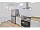 Updated kitchen with stainless steel appliances and granite countertops at 10667 Olympic Pine Dr, Las Vegas, NV 89135