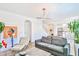 Open-concept living room showcasing contemporary decor, stylish furniture, and access to dining area at 10667 Olympic Pine Dr, Las Vegas, NV 89135