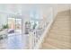 Open concept living area with stairs and glass sliding doors at 10667 Olympic Pine Dr, Las Vegas, NV 89135