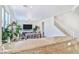Bright living room features modern furnishings, a dining area, and open staircase to the upper level at 10667 Olympic Pine Dr, Las Vegas, NV 89135