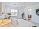 Bright main bedroom with king bed and ensuite bathroom at 10667 Olympic Pine Dr, Las Vegas, NV 89135