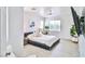 Bright main bedroom with king bed and light plank floors at 10667 Olympic Pine Dr, Las Vegas, NV 89135