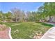 Well manicured lawn with mature shade trees on a sunny day at the community park at 10667 Olympic Pine Dr, Las Vegas, NV 89135