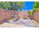 Outdoor patio area features a stone tiled floor and outdoor dining and BBQ spaces at 10667 Olympic Pine Dr, Las Vegas, NV 89135