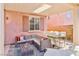 Relaxing covered patio includes a lounge area, outdoor dining, and stylish decor, perfect for outdoor living at 10667 Olympic Pine Dr, Las Vegas, NV 89135