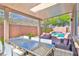Covered patio area featuring outdoor dining and seating, perfect for entertaining around the pool at 10667 Olympic Pine Dr, Las Vegas, NV 89135