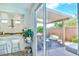 Covered patio seating area viewed through open sliding glass doors with an outdoor counter at 10667 Olympic Pine Dr, Las Vegas, NV 89135
