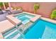 Close-up of the backyard spa features a unique tiled design, complemented by a pristine pool at 10667 Olympic Pine Dr, Las Vegas, NV 89135