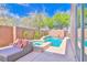 Inviting backyard features a sparkling pool and spa, perfect for relaxation and entertainment at 10667 Olympic Pine Dr, Las Vegas, NV 89135