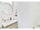 Stylish powder room featuring a modern vanity, elegant mirror, and fresh decor at 10667 Olympic Pine Dr, Las Vegas, NV 89135