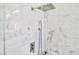 Close up of a marble shower with rain shower head and handheld sprayer at 10667 Olympic Pine Dr, Las Vegas, NV 89135