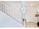 Clean, bright staircase with white railing and tile flooring leading to the upper level at 10667 Olympic Pine Dr, Las Vegas, NV 89135