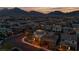 Aerial view of a residential neighborhood at dusk with mountain views in the background at 11856 Barona Mesa Ave, Las Vegas, NV 89138