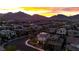 An aerial view of the neighborhood and mountains in the background during sunset at 11856 Barona Mesa Ave, Las Vegas, NV 89138
