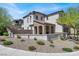 A stylish home with arched entryways, stone accents, and a well-maintained yard at 11856 Barona Mesa Ave, Las Vegas, NV 89138