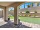 An outdoor living space featuring synthetic lawn, a brick retaining wall and covered patio at 11856 Barona Mesa Ave, Las Vegas, NV 89138