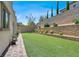 Spacious backyard with green synthetic lawn and brick retaining wall, perfect for outdoor entertaining at 11856 Barona Mesa Ave, Las Vegas, NV 89138