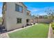 Beautiful backyard offers lush green lawn and brick paver patio with basketball hoop at 11856 Barona Mesa Ave, Las Vegas, NV 89138