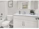Bathroom offers white vanity with marble countertop, toilet, framed mirror, and bathtub at 11856 Barona Mesa Ave, Las Vegas, NV 89138