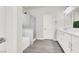 Bright bathroom with a large soaking tub, walk-in shower, dual sink vanity, and modern lighting at 11856 Barona Mesa Ave, Las Vegas, NV 89138