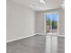 Spacious bedroom with a ceiling fan, sliding glass doors, and wood-look flooring at 11856 Barona Mesa Ave, Las Vegas, NV 89138