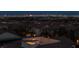 A night-time view overlooking rooftops towards the distant Las Vegas skyline and the lights of the city at 11856 Barona Mesa Ave, Las Vegas, NV 89138