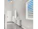 Bright entryway features white walls, wood floors, staircase, and modern console table at 11856 Barona Mesa Ave, Las Vegas, NV 89138
