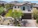 Charming two-story home with desert landscaping and a brick driveway set against a mountain backdrop at 11856 Barona Mesa Ave, Las Vegas, NV 89138