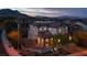 An elevated evening view of a two-story home featuring a decorative front patio at 11856 Barona Mesa Ave, Las Vegas, NV 89138
