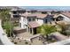 Charming two-story home featuring a tile roof, manicured front yard and stone arched entryway at 11856 Barona Mesa Ave, Las Vegas, NV 89138