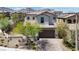A beautiful front exterior view featuring a driveway, landscaping, and a two-car garage at 11856 Barona Mesa Ave, Las Vegas, NV 89138