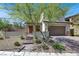 Charming home with brick accents, a two-car garage, a gated entry, and desert landscaping at 11856 Barona Mesa Ave, Las Vegas, NV 89138