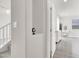 Hallway leading to bedroom with modern wood-look flooring, and neutral colored walls at 11856 Barona Mesa Ave, Las Vegas, NV 89138