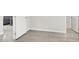 Hallway showcases wood floors, white doors, and neutral-toned walls creating an open and airy space at 11856 Barona Mesa Ave, Las Vegas, NV 89138