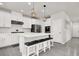 Contemporary kitchen island with white cabinets, black hardware, and seating at 11856 Barona Mesa Ave, Las Vegas, NV 89138