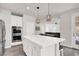Gourmet kitchen with stainless appliances, quartz countertops, and a large center island at 11856 Barona Mesa Ave, Las Vegas, NV 89138