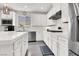 Contemporary kitchen featuring white cabinets, stainless appliances, and white quartz countertops at 11856 Barona Mesa Ave, Las Vegas, NV 89138