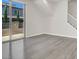 Open-concept living room features modern gray flooring and access to outdoor patio at 11856 Barona Mesa Ave, Las Vegas, NV 89138