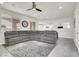 Spacious living room with a large sectional sofa, stylish rug, and ample natural light, ideal for relaxation at 11856 Barona Mesa Ave, Las Vegas, NV 89138