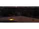 Night scene of the Las Vegas skyline behind a residential neighborhood with roof top patio at 11856 Barona Mesa Ave, Las Vegas, NV 89138